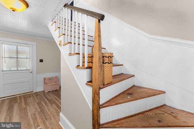 1838 Muddy Gut Rd, Dunnsville, VA 22454 - stairway with wood finished floors, wainscoting, and ornamental molding