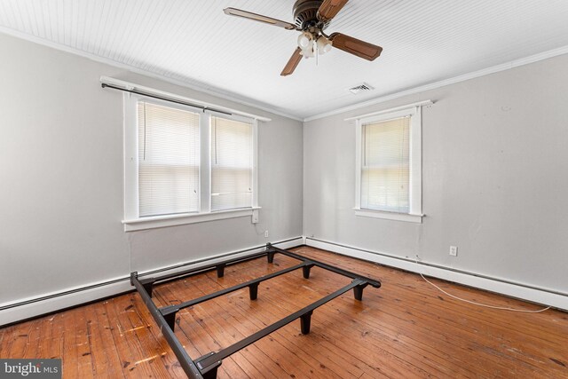 1838 Muddy Gut Rd, Dunnsville, VA 22454 - empty room featuring ornamental molding, plenty of natural light, hardwood / wood-style flooring, ceiling fan, and a baseboard heating unit