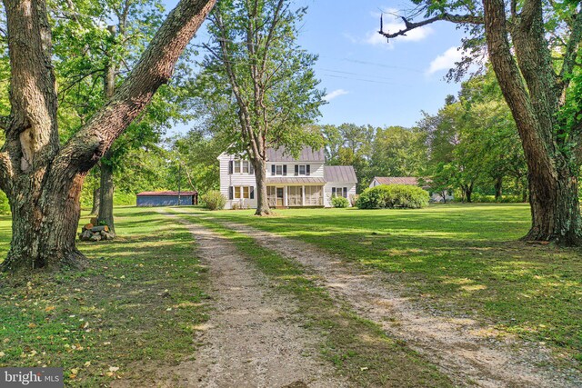 1838 Muddy Gut Rd, Dunnsville, VA 22454 - view of front of property with a front yard, dirt driveway, metal roof, and a standing seam roof