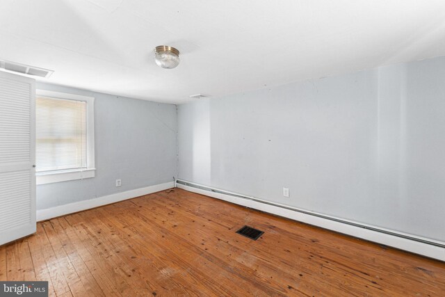 1838 Muddy Gut Rd, Dunnsville, VA 22454 - spare room with baseboard heating, hardwood / wood-style floors, and baseboards