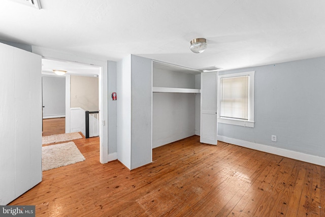 1838 Muddy Gut Rd, Dunnsville, VA 22454 - unfurnished bedroom with hardwood / wood-style flooring, baseboards, a closet, and a baseboard radiator