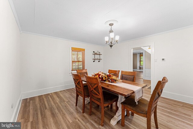 1838 Muddy Gut Rd, Dunnsville, VA 22454 - dining room with a chandelier, plenty of natural light, crown molding, and light wood-style flooring