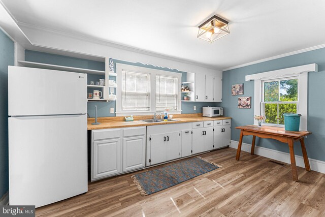 1838 Muddy Gut Rd, Dunnsville, VA 22454 - kitchen featuring white appliances, open shelves, crown molding, a sink, and light wood-style floors