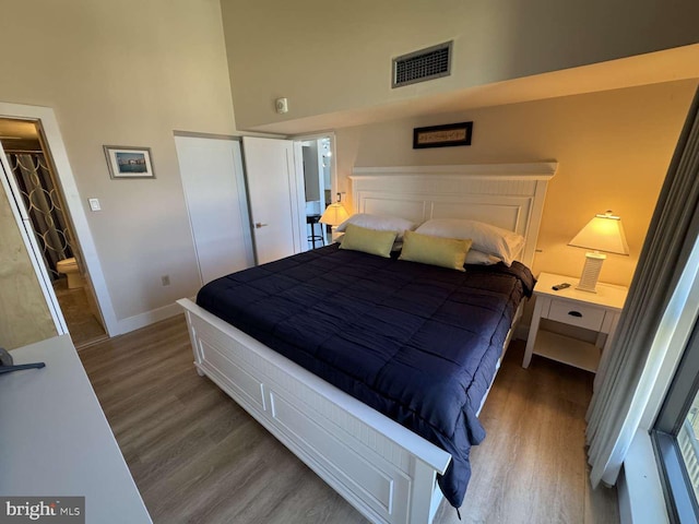 911 Harbour House Rd Unit 911, Bethany Beach, DE 19930 - bedroom featuring wood finished floors, baseboards, a closet, and a high ceiling