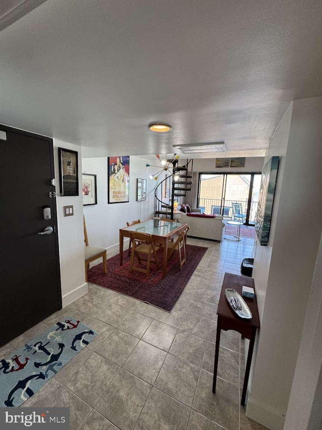 911 Harbour House Rd Unit 911, Bethany Beach, DE 19930 - living room featuring tile patterned floors, baseboards, and a chandelier