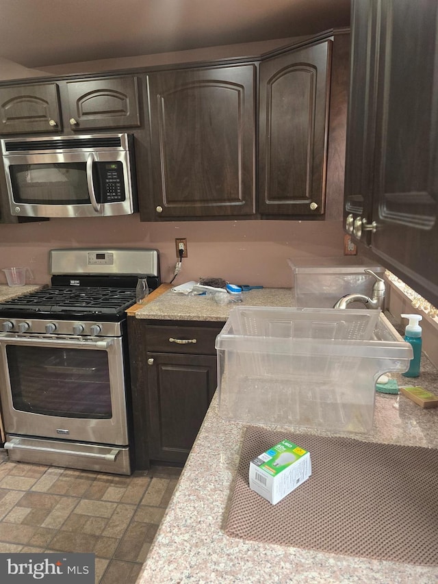 233 S 58th St, Philadelphia, PA 19139 - kitchen with stainless steel appliances, dark brown cabinets, and light countertops