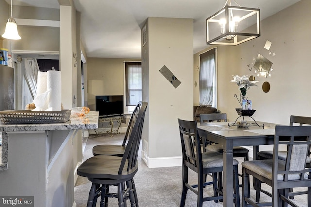 5109 Ivanhoe Ave, Baltimore, MD 21212 - carpeted dining space featuring a chandelier and baseboards