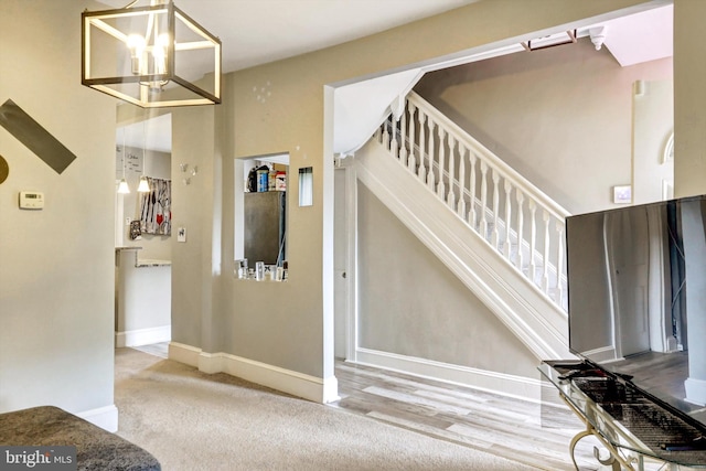 5109 Ivanhoe Ave, Baltimore, MD 21212 - stairway featuring baseboards, carpet floors, and a chandelier
