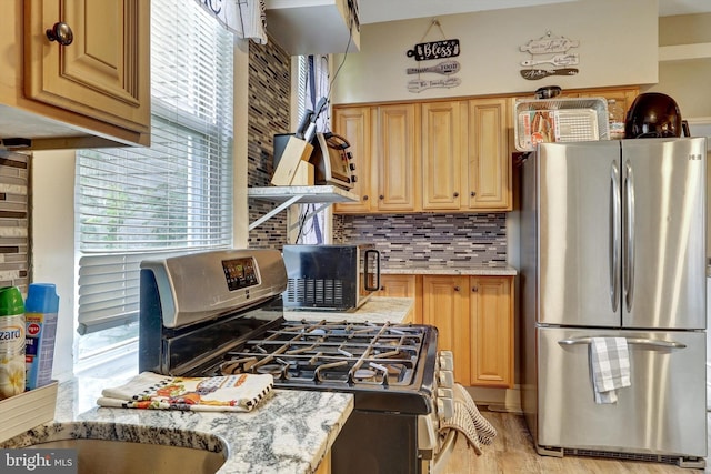 5109 Ivanhoe Ave, Baltimore, MD 21212 - kitchen with appliances with stainless steel finishes, healthy amount of natural light, decorative backsplash, and light stone counters