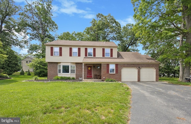 7 Quail Ct, Wilmington, DE 19810 - view of front of home with an attached garage, brick siding, asphalt driveway, and a front lawn