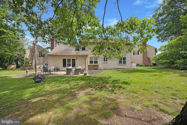 7 Quail Ct, Wilmington, DE 19810 - back of house with a yard, an outdoor living space with a fire pit, a chimney, and a patio area