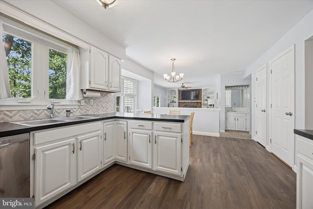 7 Quail Ct, Wilmington, DE 19810 - kitchen with a sink, dishwasher, a chandelier, dark countertops, and a peninsula