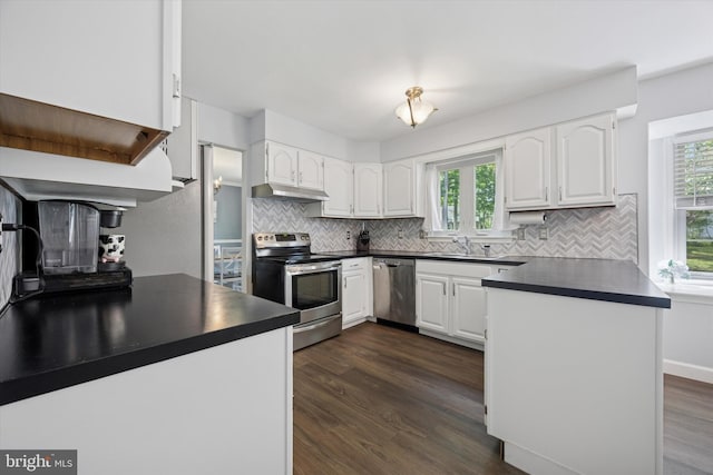 7 Quail Ct, Wilmington, DE 19810 - kitchen with appliances with stainless steel finishes, dark countertops, under cabinet range hood, and a sink
