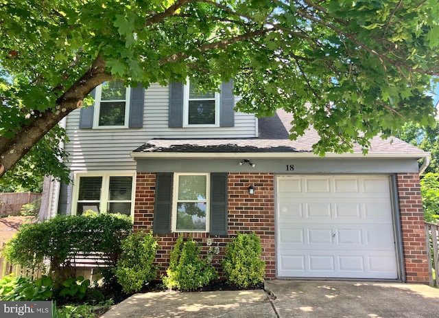 18 Huxley Cir, Abingdon, MD 21009 - view of front facade featuring a garage, driveway, brick siding, and roof with shingles