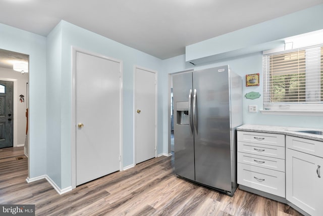 18 Huxley Cir, Abingdon, MD 21009 - kitchen with stainless steel fridge with ice dispenser, light wood-style flooring, white cabinetry, and baseboards