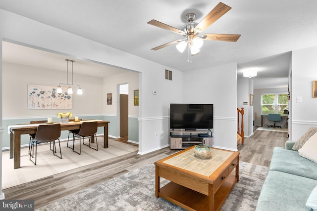 18 Huxley Cir, Abingdon, MD 21009 - living room featuring light wood-type flooring, a ceiling fan, baseboards, and a chandelier