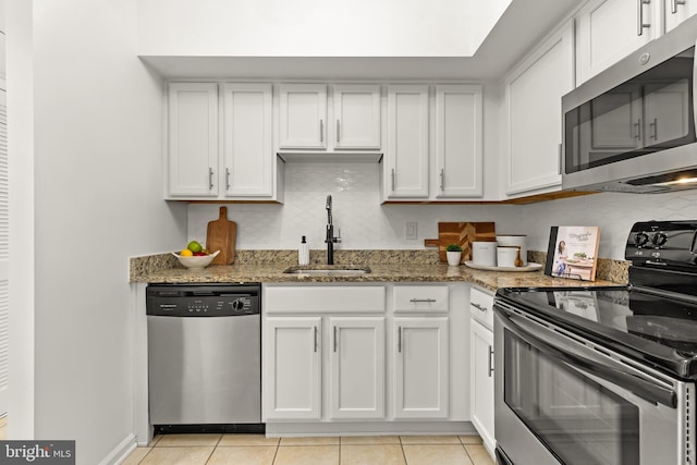 1001 N Randolph St Unit 910, Arlington, VA 22201 - kitchen with stainless steel appliances, a sink, white cabinetry, and light stone countertops