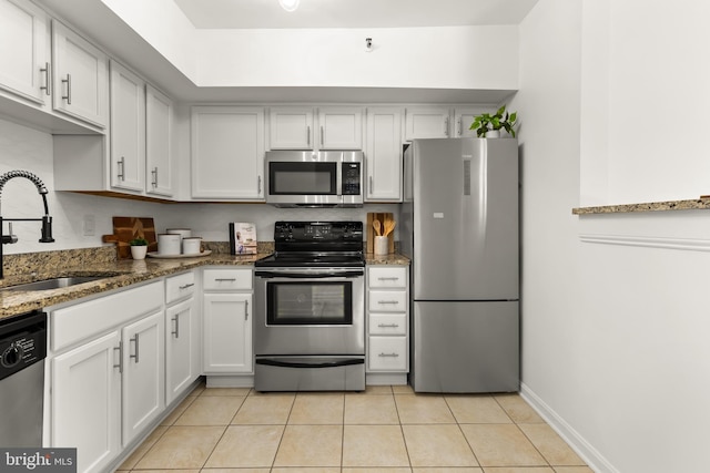 1001 N Randolph St Unit 910, Arlington, VA 22201 - kitchen featuring appliances with stainless steel finishes, a sink, light tile patterned flooring, white cabinets, and stone counters