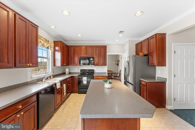 kitchen with black appliances, a sink, recessed lighting, light tile patterned floors, and a kitchen island