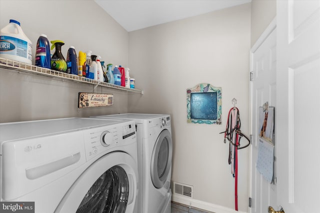laundry area featuring washer and dryer and baseboards