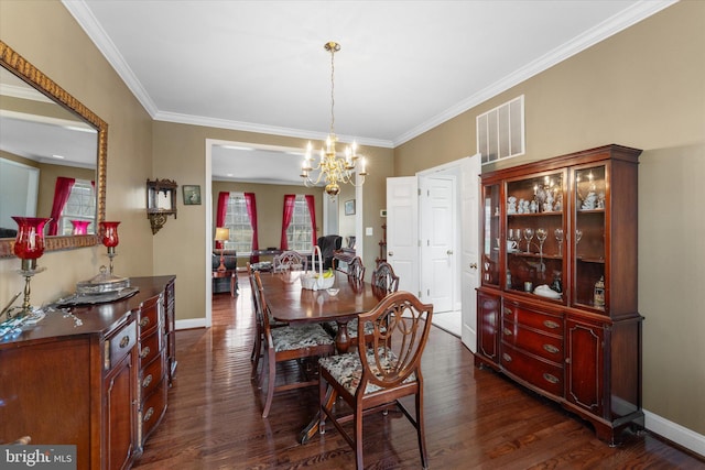 dining space featuring dark wood-style floors, a chandelier, ornamental molding, and baseboards