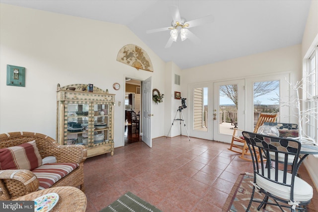 living room with a ceiling fan, french doors, baseboards, and high vaulted ceiling
