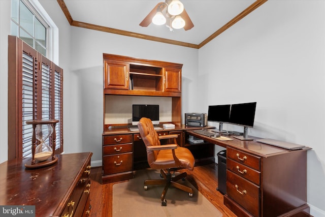 office area featuring ornamental molding, dark wood finished floors, ceiling fan, and baseboards