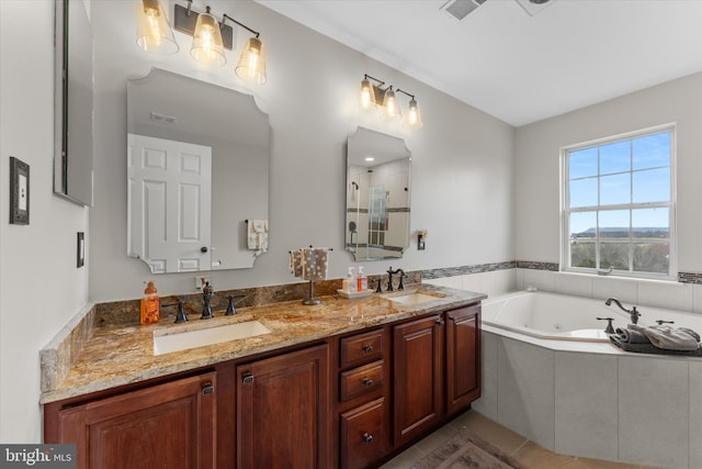 bathroom with a shower stall, a jetted tub, double vanity, and tile patterned flooring