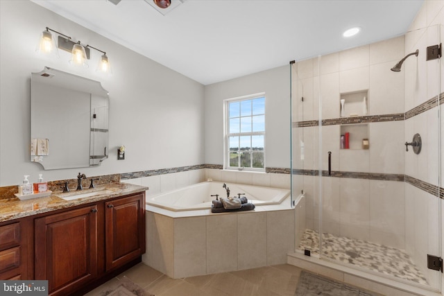 full bath with a stall shower, a bath, tile patterned floors, and vanity