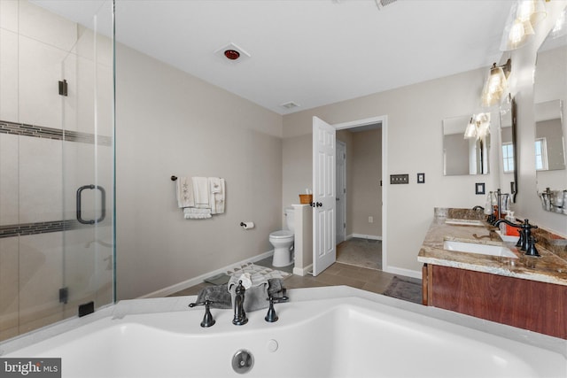 bathroom featuring toilet, a garden tub, a shower stall, double vanity, and baseboards