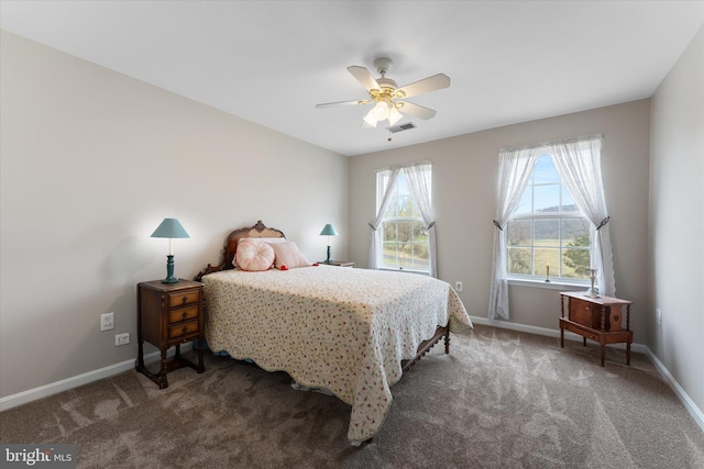 carpeted bedroom with baseboards and a ceiling fan