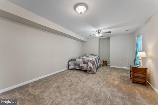 carpeted bedroom featuring baseboards and a ceiling fan