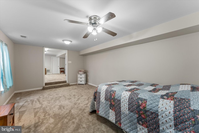 carpeted bedroom with baseboards and a ceiling fan