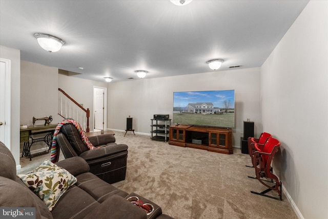 living room with stairway, carpet floors, and baseboards