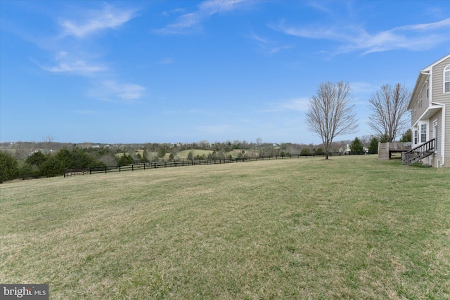 view of yard featuring a wooden deck and a rural view