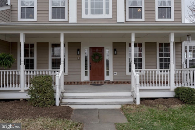 view of exterior entry with a porch