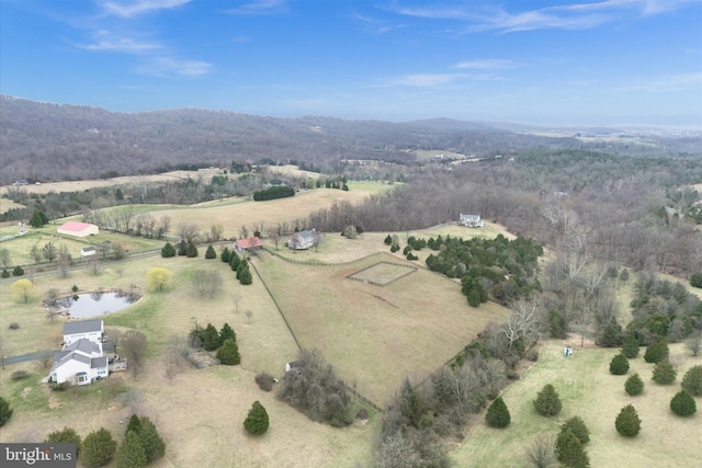 aerial view of property and surrounding area featuring rural landscape and a mountainous background