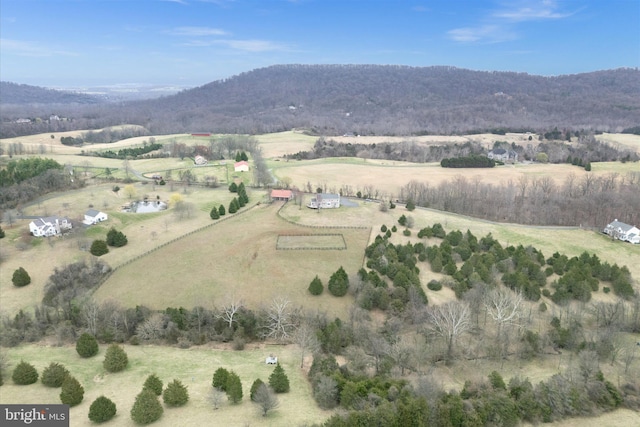 aerial view of property and surrounding area with rural landscape and a mountainous background