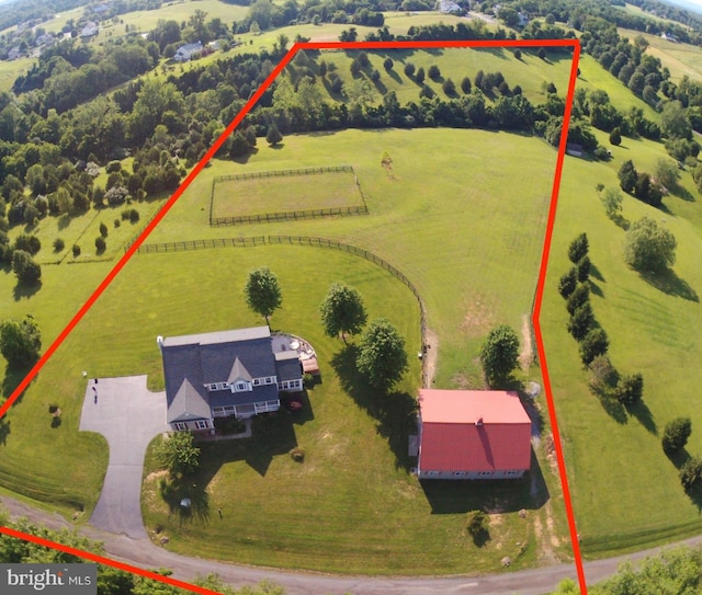 aerial view of sparsely populated area with property parcel outlined and agricultural land