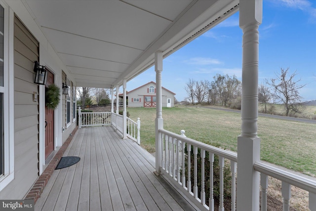 deck with covered porch and a lawn