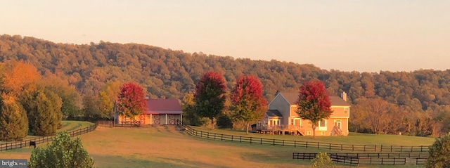 aerial view at dusk of a wooded view and a rural view