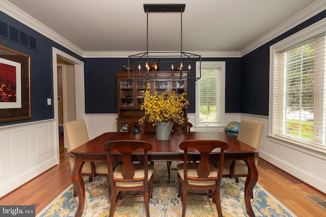 8 Fallbrook Ln, Glen Mills, PA 19342 - dining space featuring a chandelier, wainscoting, wood finished floors, crown molding, and a decorative wall