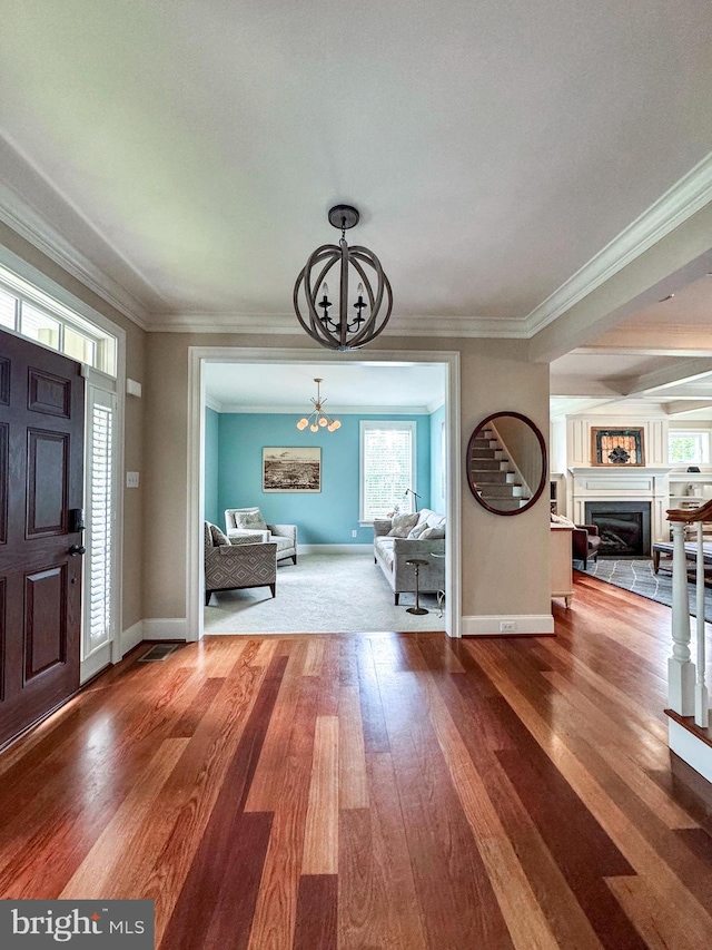 8 Fallbrook Ln, Glen Mills, PA 19342 - foyer entrance with a chandelier, hardwood / wood-style floors, baseboards, a glass covered fireplace, and crown molding