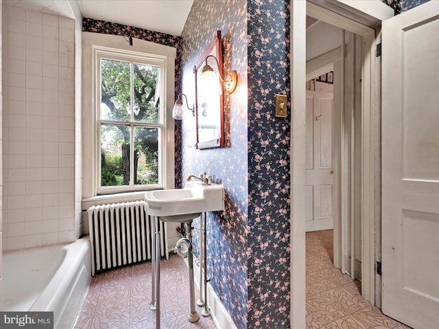45 Front St, Lititz, PA 17543 - full bathroom featuring radiator heating unit, wallpapered walls, tile patterned floors, and a tub to relax in