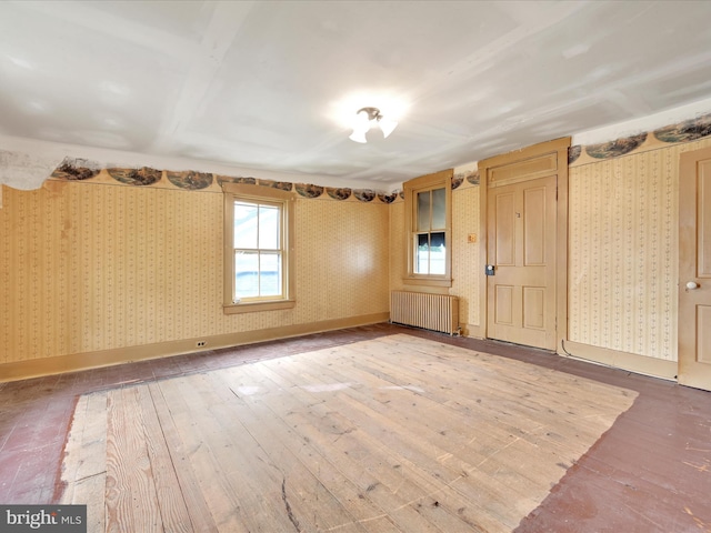 45 Front St, Lititz, PA 17543 - unfurnished room with radiator heating unit, wallpapered walls, and hardwood / wood-style flooring