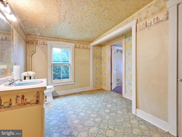 45 Front St, Lititz, PA 17543 - bathroom featuring toilet, vanity, wallpapered walls, baseboards, and stone finish flooring