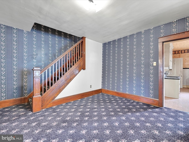 45 Front St, Lititz, PA 17543 - unfurnished room with wallpapered walls, baseboards, stairway, carpet, and a sink