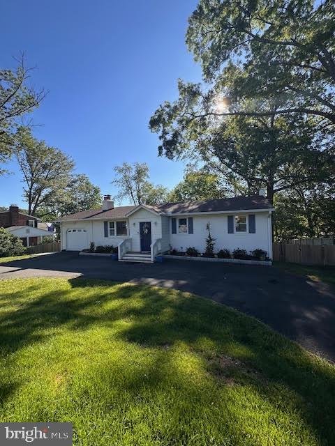 8313 Accotink Rd, Lorton, VA 22079 - single story home featuring driveway, a garage, and a chimney