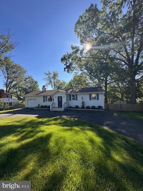 8313 Accotink Rd, Lorton, VA 22079 - single story home featuring driveway, an attached garage, and a chimney