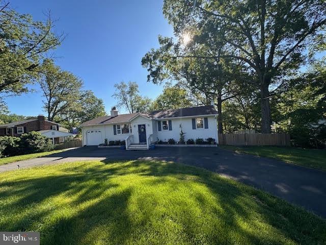 8313 Accotink Rd, Lorton, VA 22079 - view of front of home with asphalt driveway, an attached garage, and a chimney